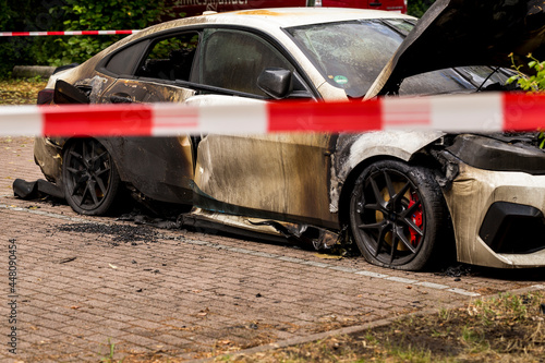 Car insurance roperty loss crime scene: daylight view of parking lot exterior where arsonist set fire to parked vehicles. Vandalism on the street leaves several cars burned, in irreparable state 