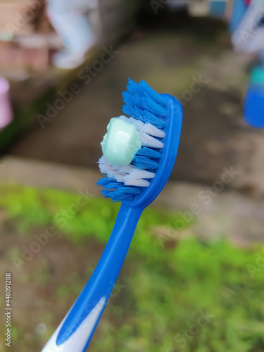 Closeup view of toothbrush with toothpaste blur background