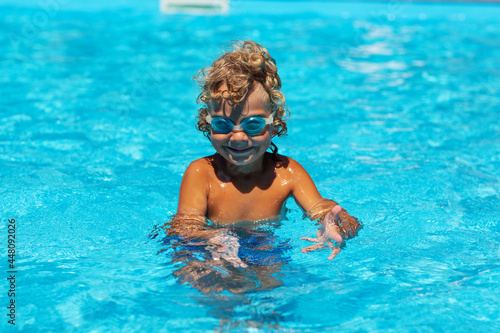 Curly boy in the pool with glasses © Maygutyak