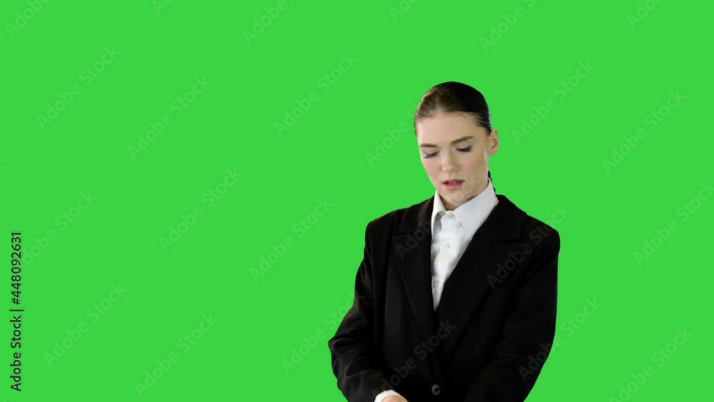 Young woman adjusting her office suit, crossing arms, putting hand on hip on a Green Screen, Chroma Key. Young woman adjusting her office suit, crossing arms, putting hand on hip on a Green Screen, Chroma Key.