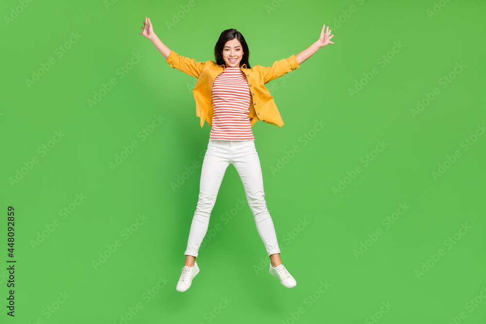 Full length photo of cute brown hairdo young lady jump wear shirt trousers sneakers isolated on green color background Full length photo of cute brown hairdo young lady jump wear shirt trousers sneakers isolated on green color background