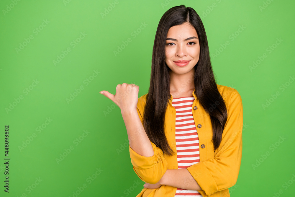 Photo of lovely brunette hairdo millennial lady point empty space wear shirt isolated on green color background Photo of lovely brunette hairdo millennial lady point empty space wear shirt isolated on green color background