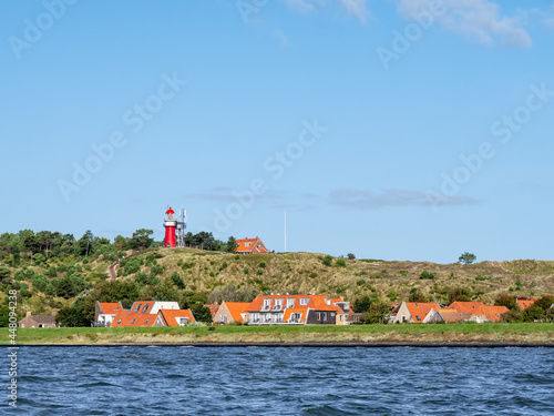 Vlieland with Vuurduin lighthouse on vuurboetsduin and East-Vlieland town from Waddensea, Friesland, Netherlands photo