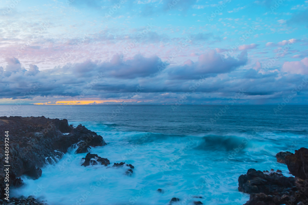 Long exposure shot of Stormy waves and rocky shore. Santa Cruz de Tenerife, Canary Islands, Spain Long exposure shot of Stormy waves and rocky shore. Santa Cruz de Tenerife, Canary Islands, Spain