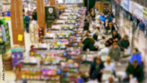Cashier at supermarket / Retail checkout / Paying groceries. Unrecognizable buyers with carts move in queues to pay for purchases at the supermarket cashier. Fast motion.