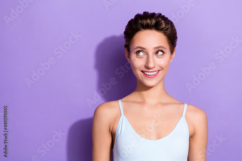 Photo portrait girl in blue top smiling looking copyspace isolated pastel violet color background