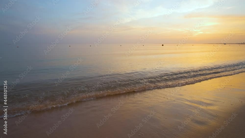 Calm sea shore with crushing waves on sandy beach at sunrise. Calm sea shore with crushing waves on sandy beach at sunrise.