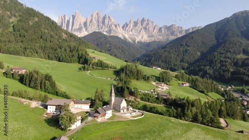 Flying over Santa Maddalena village (St Magdalena) in Dolomites mountains, Italy photo