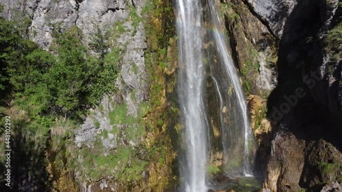 Beautiful Theth waterfall near Theth village in Albanian alps mountains. Majestic cascade waterfall into the forest in slow motion, Accursed mountains, Albania photo