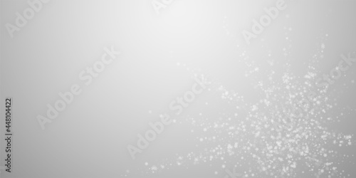 Beautiful snowfall Christmas background. Subtle flying snow flakes and stars on light grey background. Artistic winter silver snowflake overlay template. Positive vector illustration.