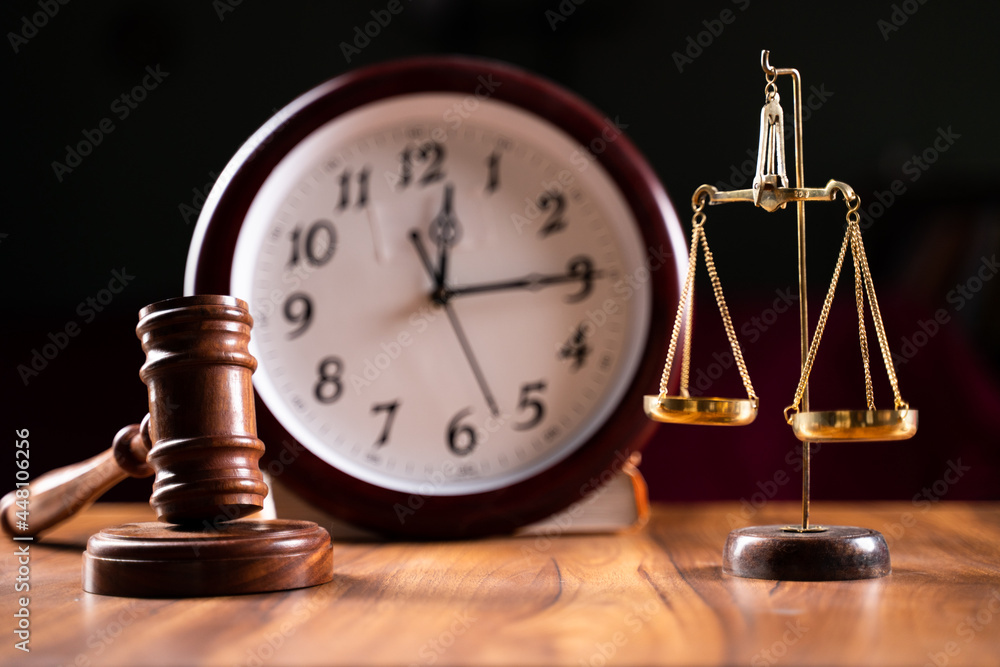 Concept showing of Problems with legal system, delay or slow in judicial justice system by using judge hammer, balance scale and wall clock. - obrazy, fototapety, plakaty 
