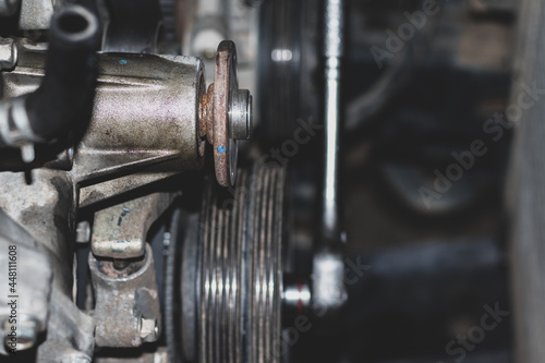 The mechanic is checking the engine.