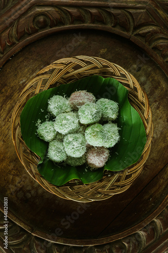 kelepon or klepon or onde-onde made from glutinous rice flour and filled with brownn sugar covered with grated coconut. Some people called this traditional cake from Indonesia as Onde-onde. photo