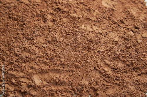 Cocoa powder texture. Food background. Brown powder pattern.