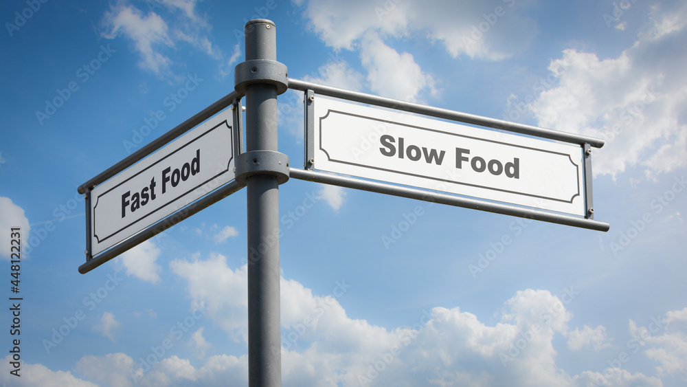 Obraz premium Street Sign Slow versus Fast Food