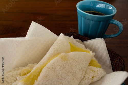 Duas tapiocas recheadas com mussarela e uma xícara de café. photo