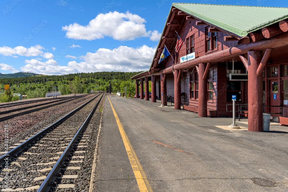 Amtrak Train Station - A Spring morning view of the platform of an Amtrak Train Station at East Glacier Park Village, located just outside of Glacier National Park. Montana, USA. Amtrak Train Station - A Spring morning view of the platform of an Amtrak Train Station at East Glacier Park Village, located just outside of Glacier National Park. Montana, USA.