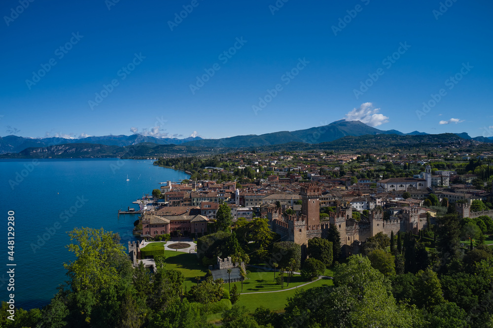 Aerial view of the Scaliger Castle of Lazise. Lazise Lake Garda Italy. Top view of the historic part of the city Lazise Castle on the coastline of Lake Garda. Panorama of the historic town of Lazise
