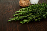 Fresh rosemary bound on brown  wooden board with twine. Healthy organic concept. Aroma herb for cooking
