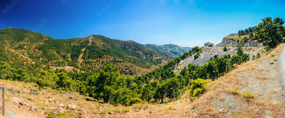 Panoramic View Of Mountains Landscape and serpentine road in Malaga region, Andalusia, Spain. Summer
