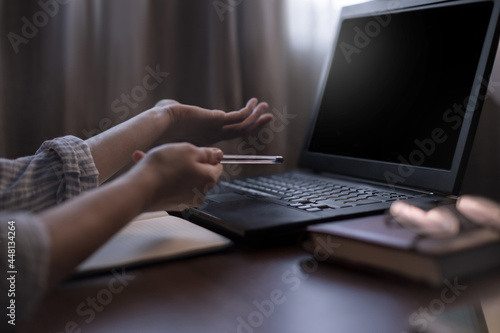 female hands working at the computer. Hand gestures. Study, business. Work at home, room for text, black screen. Comfortable atmosphere in brown background