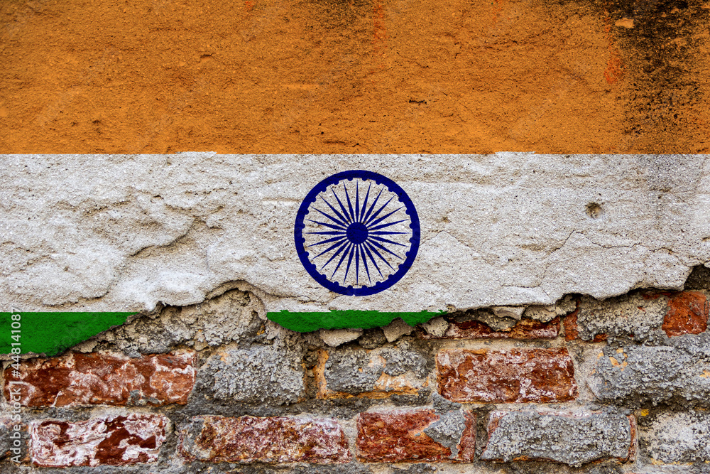 Graphic Concept with a Flag of India painted on a damaged brick wall.
