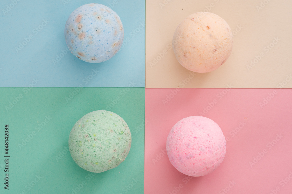 bath bombs pink, cream, blue and green on coloured background bath bombs pink, cream, blue and green on coloured background