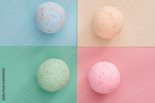 bath bombs pink  cream  blue and green on coloured background