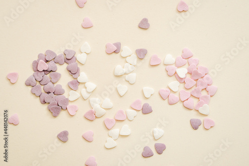 sprinkling for sweets in the shape of hearts in white, purple and pink colours