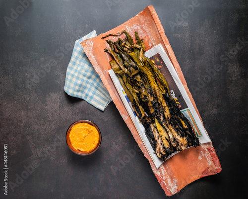 Grilled spring onions with romesco sauce. Spanish cuisine photo