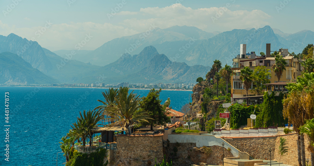 Naklejka premium ANTALYA, TURKEY: Top view of the old town, the sea and the mountains on a sunny summer day in Antalya.