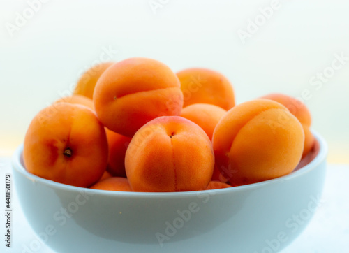 Apricots fresh, juicy, delicious summer snack in a white bowl