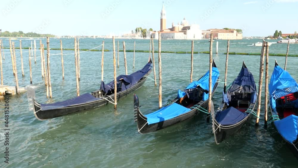 Venice, Italy - gondolas and gondoliers in the Grand Canal near the Rialto Bridge, in the San Marco Basin and between the canals of the lagoon city Venice, Italy - gondolas and gondoliers in the Grand Canal near the Rialto Bridge, in the San Marco Basin and between the canals of the lagoon city