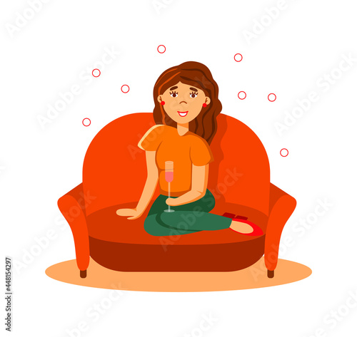 Young happy rich woman drinking champagne sitting on sofa