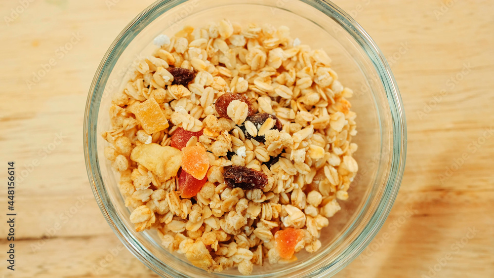 Pouring muesli breakfast mix in bowl. Close up shot Pouring muesli breakfast mix in bowl. Close up shot