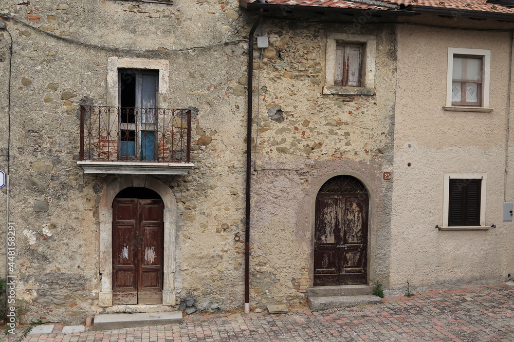 Old Stone House Facades with Wooden Doors, Windows and Iron Balcony in Central Italy