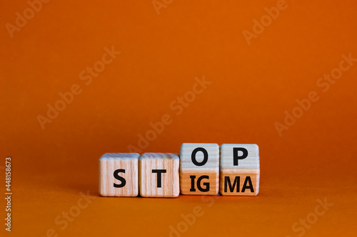 Stop stigma symbol. Turned wooden cubes with words stop stigma. Beautiful orange background. Medical and stop stigma concept. Copy space. photo