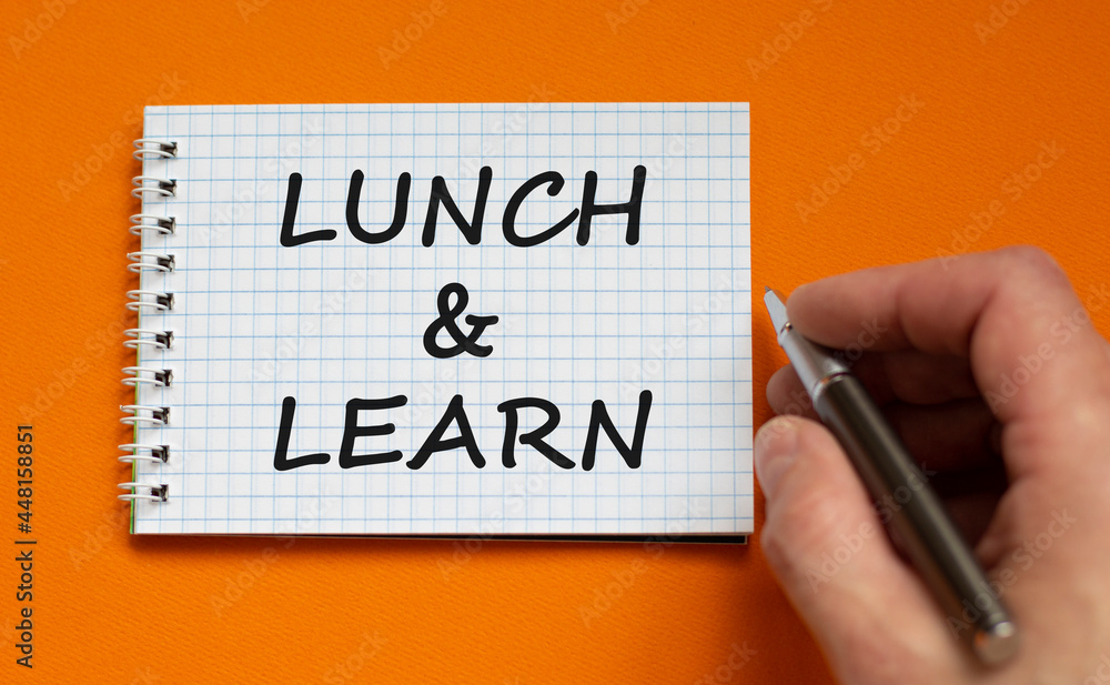 Lunch and learn symbol. Businessman writing words 'Lunch and learn' on white note. Beautiful orange background. Business, educational and lunch and learn concept. Copy space. Lunch and learn symbol. Businessman writing words 'Lunch and learn' on white note. Beautiful orange background. Business, educational and lunch and learn concept. Copy space.