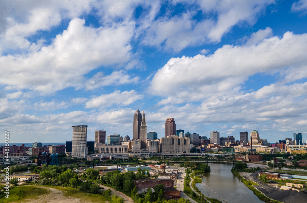 Downtown Cleveland from the air, with the Cuyahoga River cutting through the right foreground on a beautiful sunny day Downtown Cleveland from the air, with the Cuyahoga River cutting through the right foreground on a beautiful sunny day
