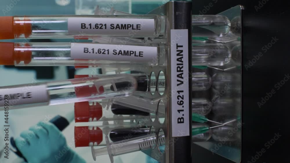 B.1.621 Test Tube Samples Being Placed Into Rack. Vertical Video, Locked Off B.1.621 Test Tube Samples Being Placed Into Rack. Vertical Video, Locked Off