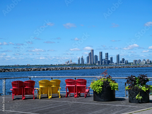 Obraz na plátně Colorful chairs on Toronto's waterfront boardwalk, with a view  of modern condom