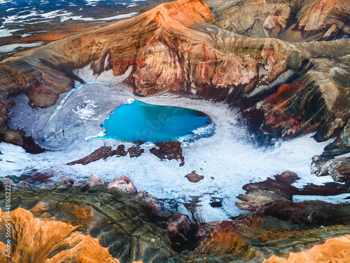 Blue lake in the crater of Gorely volcano in Kamchatka peninsula, Russia. Aerial drone view. Beautiful landscape at sunrise.