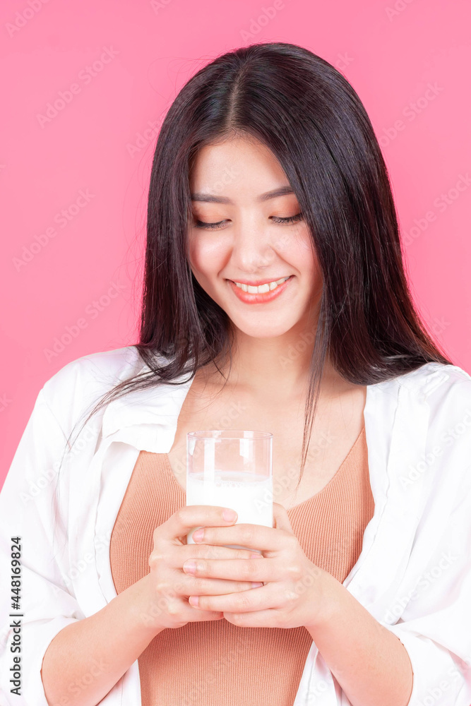 beauty woman Asian cute girl feel happy drinking milk for good health in the morning on pink background - lifestyle beauty woman concept beauty woman Asian cute girl feel happy drinking milk for good health in the morning on pink background - lifestyle beauty woman concept