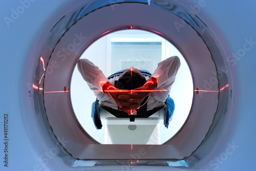 patient entering an MRI machine to produce a detailed and internal image of their organs to diagnose the possible cause of their illness or discomfort