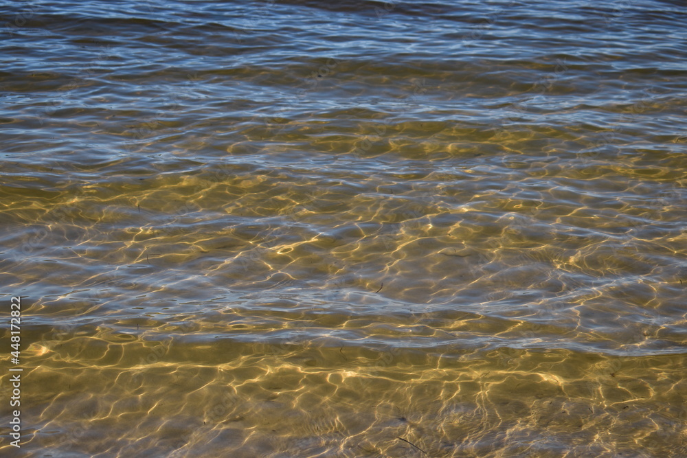 sunlight diffraction patterns in shallow water at a low energy coastline