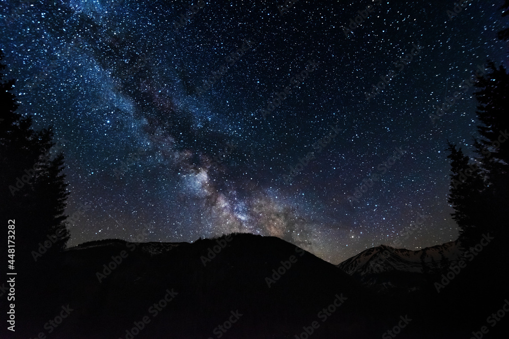 Bright starry sky with the milky way on the background of High Tatras mountains 