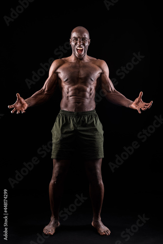 African American man facing front with hands open and shouting at camera © Iván Moreno