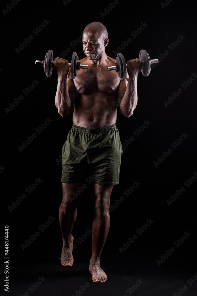 Front view of a muscular man standing doing exercise for biceps Front view of a muscular man standing doing exercise for biceps
