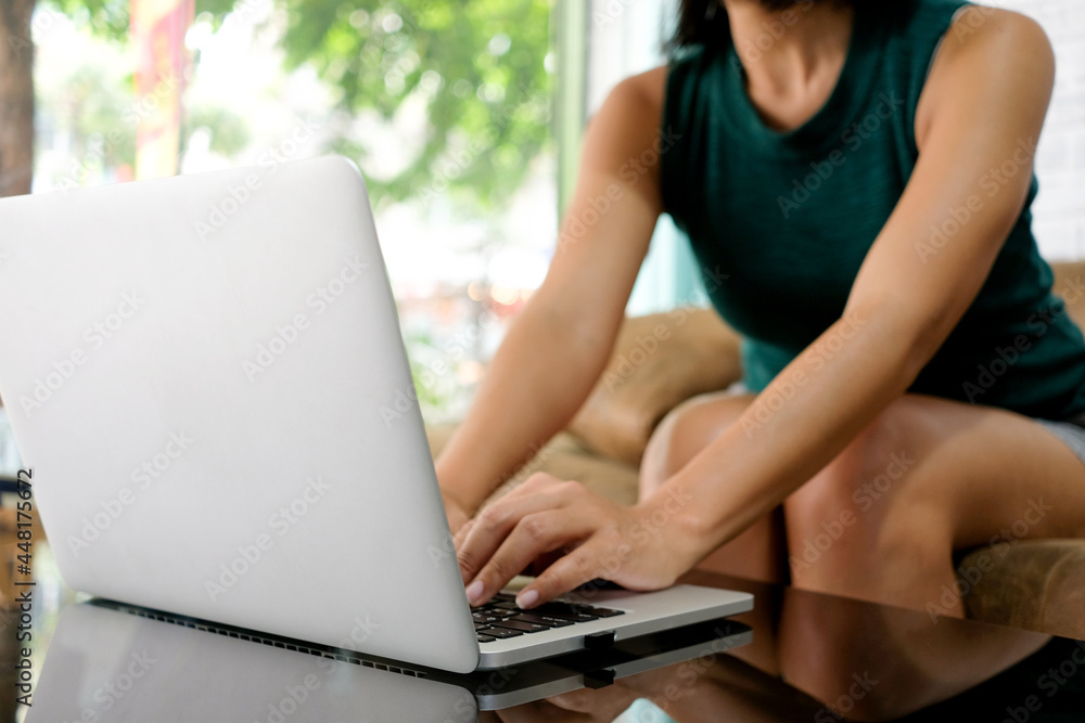 Fototapeta premium Women sitting in front of the computer She is thinking and reviewing the notebook computer screen at the computer desk she has headaches and stress. Cause of hard work and insufficient rest