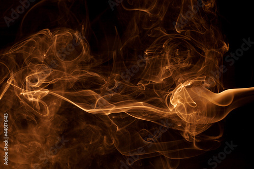 Movement gold smoke on black background.